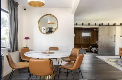 a dining room with a table and chairs and a mirror at Party House Heaven in North Hollywood