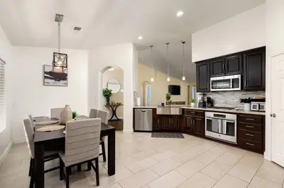 a kitchen and dining room with a table and chairs at Perfect Home for Work or Relaxing Vacation in Bakersfield