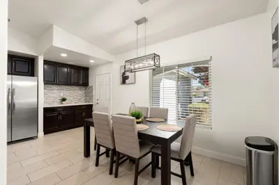 a kitchen and dining room with a table and chairs at Perfect Home for Work or Relaxing Vacation in Bakersfield