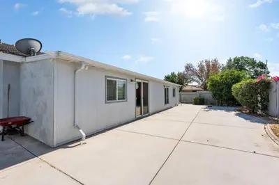 a white building with a red bench next to it at Perfect Home for Work or Relaxing Vacation in Bakersfield