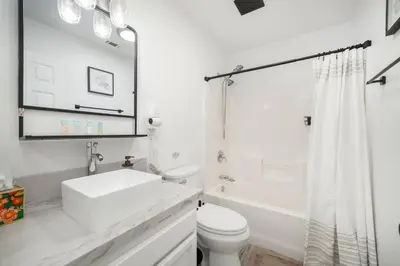 a white bathroom with a sink and a toilet at Simple Home for Work or Travel in Bakersfield