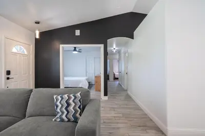 a living room with a couch and a bedroom at Simple Home for Work or Travel in Bakersfield