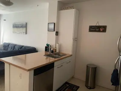 a kitchen with a counter and a refrigerator at Tucked in Little Tokyo in Los Angeles