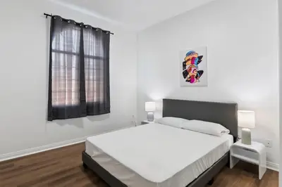 a white bedroom with a large bed and a window at Lovely gated 3bedroom & 2 bath unit near Universal studio and Hollywood in North Hollywood