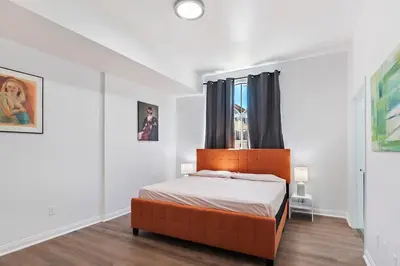 a bedroom with a bed with a orange headboard and a window at Lovely gated 3bedroom & 2 bath unit near Universal studio and Hollywood in North Hollywood