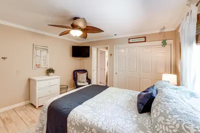 a bedroom with a bed and a ceiling fan at Pet-Friendly Riverside Retreat with Private Spa! in Riverside