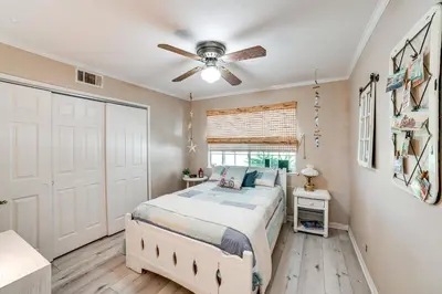a bedroom with a bed and a ceiling fan at Pet-Friendly Riverside Retreat with Private Spa! in Riverside