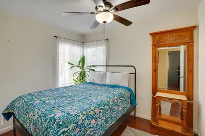a bedroom with a bed and a ceiling fan at 5 Mi to Coast Centrally Located Long Beach Home! in Long Beach
