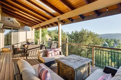 a porch with a couch and chairs on a deck at Lake Arrowhead Cabin 4 Decks, Game Room and More! in Lake Arrowhead