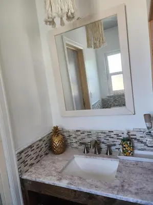 a bathroom with a sink and a mirror at The Coastal Comfort in Oxnard