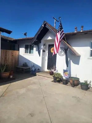 a house with an american flag in front of it at The Coastal Comfort in Oxnard
