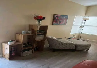 a living room with a couch and a chair at Be our Guest Hm Tampa in Palmdale
