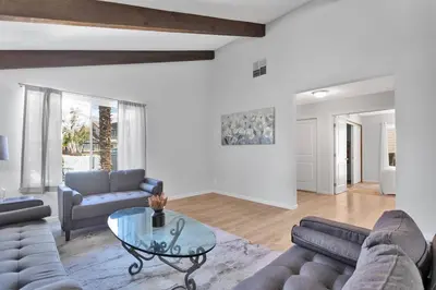 a living room with two couches and a glass table at High Desert Dream on the Fairway WiFi Smart TVs in Victorville