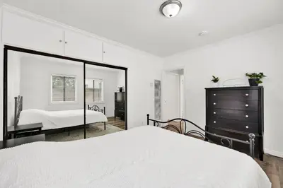 a bedroom with a bed and a dresser and a mirror at Cozy Elegant Oasis With Parking in Los Angeles