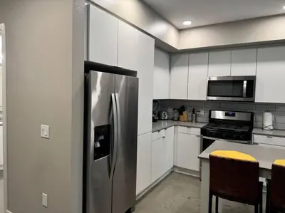 a kitchen with a stainless steel refrigerator at Spacious and Modern 3 bedroom 2 unit in Los Angeles