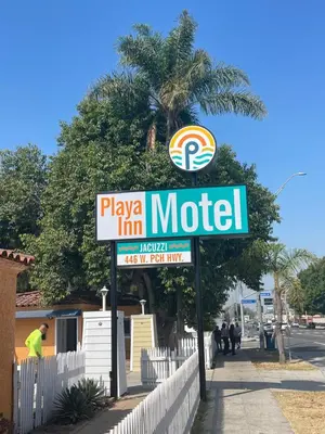 a sign for a motel on the side of a street at Playa Inn Motel - Long Beach, LA in Long Beach