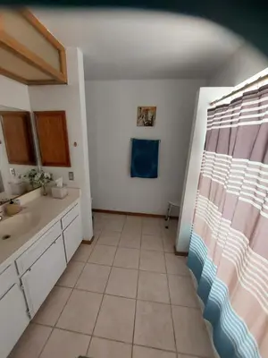 a bathroom with a sink and a tiled floor at Lyons lovely house in Hesperia