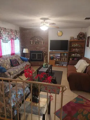 a living room with a couch and a tv at Lyons lovely house in Hesperia