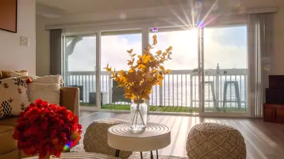 a living room with a vase of flowers on a table at Oceanfront 2BR 2BA with Stunning View 333 in Redondo Beach