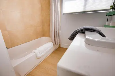 a bathroom with a sink and a bath tub at Cozy Private Studio in Granada Hills Near CSUN, Universal in Mission Hills
