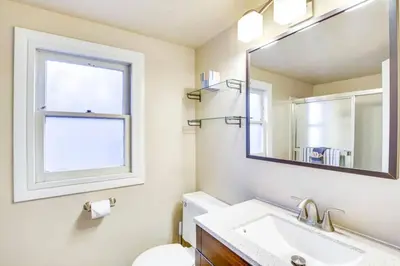 a bathroom with a sink and a mirror at The Twin Pines Chalet, 2 min to Village, BBQ in Big Bear Lake