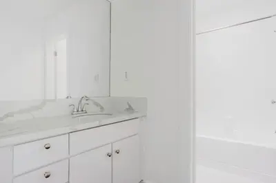 a white bathroom with a sink and a mirror at Blueground Mid-Wilshire pool nr retail LAX-1266 in Los Angeles