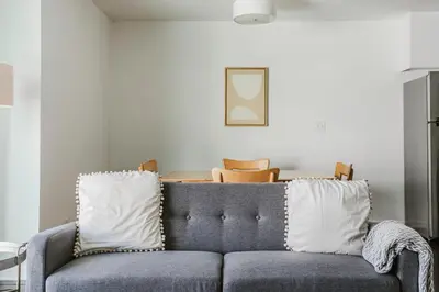a blue couch with white pillows in a living room at Blueground Mid-Wilshire pool nr retail LAX-1266 in Los Angeles