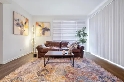 a living room with a brown couch and a table at 14 Santa Monica Gorgeous Apartment in Los Angeles