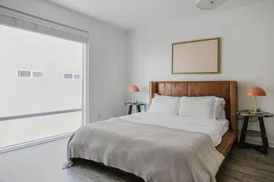 a bedroom with a bed and a large window at Blueground Mid-Wilshire pool ac nr retail LAX-1265 in Los Angeles