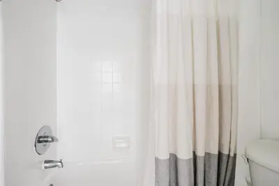a bathroom with a shower with a shower curtain at Blueground Mid-Wilshire pool ac nr retail LAX-1265 in Los Angeles