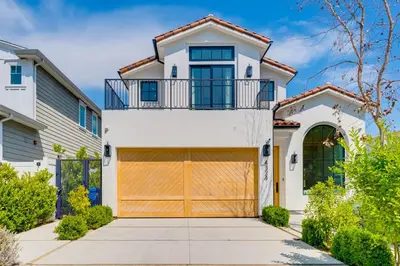a white house with a brown garage at Villa Camellia in Los Angeles