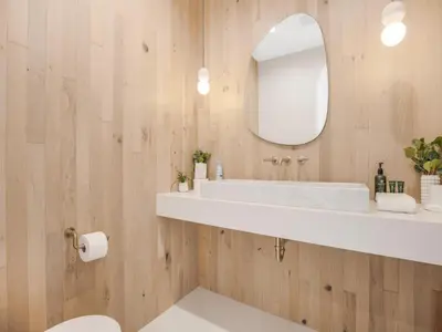 a bathroom with a white sink and a mirror at Villa Camellia in Los Angeles