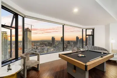 a pool table in a room with large windows at Downtown LA with the breathtaking view 2 bedrooms and parking space in Los Angeles