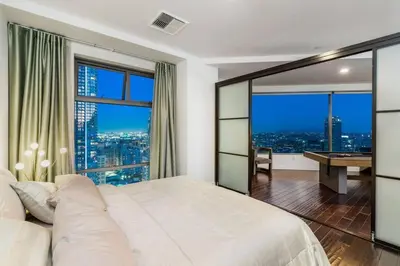 a bedroom with a bed and a desk with a view at Downtown LA with the breathtaking view 2 bedrooms and parking space in Los Angeles
