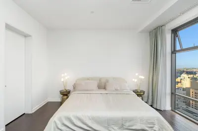 a white bedroom with a large bed and a window at Downtown LA with the breathtaking view 2 bedrooms and parking space in Los Angeles