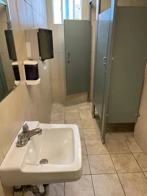 a bathroom with a sink and a shower at Randolph Hotel in Huntington Park