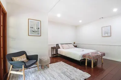a bedroom with a bed and a chair and a table at 3-Bedroom Sherman Oaks House Near Universal Studios in Los Angeles