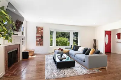 a living room with a couch and a fireplace at 3-Bedroom Sherman Oaks House Near Universal Studios in Los Angeles