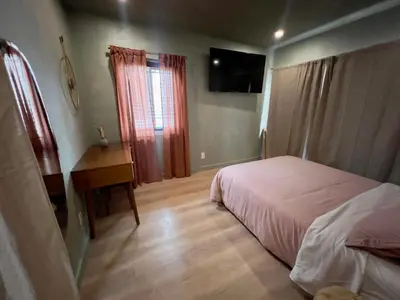a bedroom with a bed and a desk and a television at 2 Bedroom Tulum Oasis in Hollywood in Los Angeles