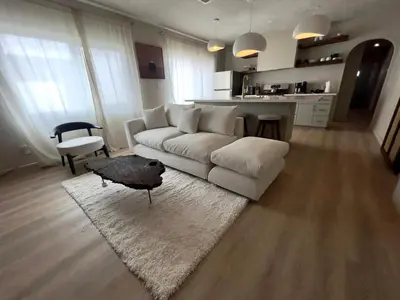 a living room with a white couch and a table at 2 Bedroom Tulum Oasis in Hollywood in Los Angeles