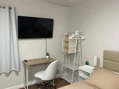 a room with a desk and a television on a wall at Pristine & Smart freshly remodeled house! in Lancaster