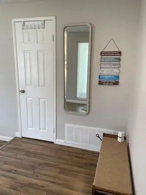 a room with a door and a mirror and a table at Pristine & Smart freshly remodeled house! in Lancaster
