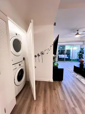 a laundry room with a washing machine and a washer at Luxury Open BD w Pool, Parking, & WD 133 in Los Angeles