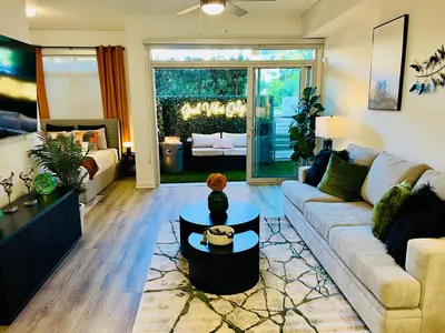 a living room with a couch and a table at Luxury Open BD w Pool, Parking, & WD 133 in Los Angeles