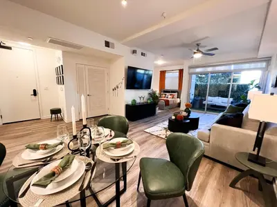 a dining room and living room with a table and chairs at Luxury Open BD w Pool, Parking, & WD 133 in Los Angeles