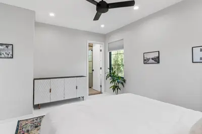 a white bedroom with a bed and a ceiling fan at Bohemian Beach ## in Los Angeles