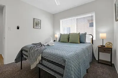 a bedroom with a large bed and a window at 6th Haven, Arcade, King Bed, Games, 1 Mile to Beaches in Long Beach