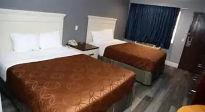 a hotel room with two beds in a room at Grand Park Inn in Baldwin Park