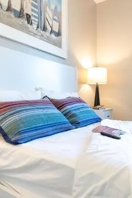 a white bed with a book on top of it at Comfy and Stylish 4 Bathrooms 26 in Ridgecrest