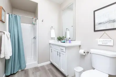 a bathroom with a shower toilet and a sink at Luxury, Style and Comfort 4 Bathrooms 21 in Ridgecrest